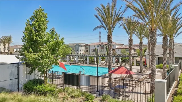 a view of swimming pool with a table and chairs