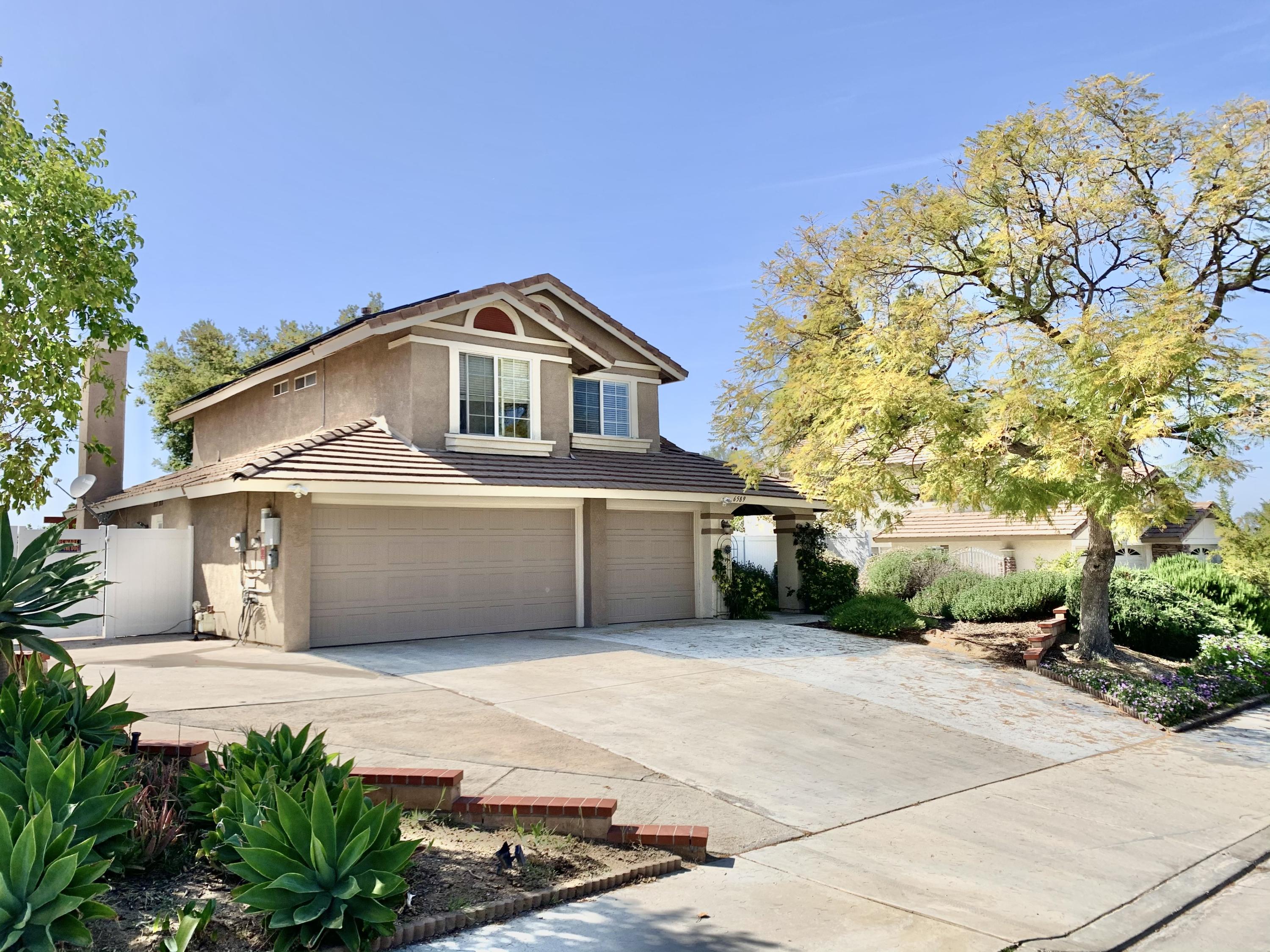 6589 Hawkley Drive Riverside, CA 92506 - Photo 1 of 29 a front view of a house with a garden