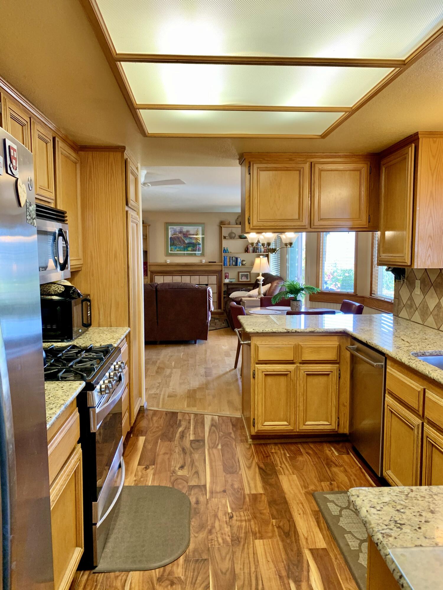 6589 Hawkley Drive Riverside, CA 92506 - Photo 7 of 29 a kitchen with stainless steel appliances granite countertop a sink stove and granite counter top