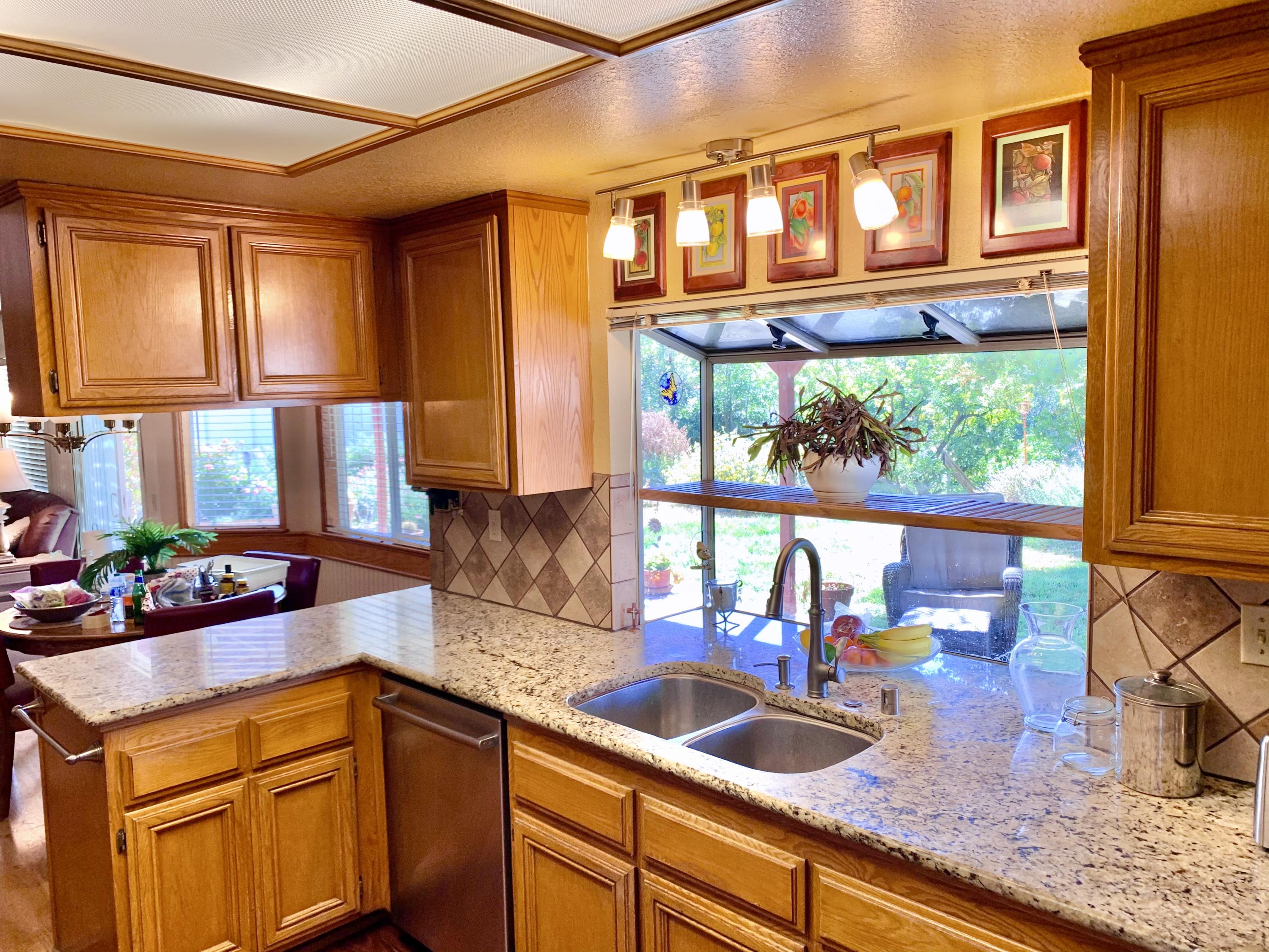 6589 Hawkley Drive Riverside, CA 92506 - Photo 8 of 29 a kitchen that has a sink and large window