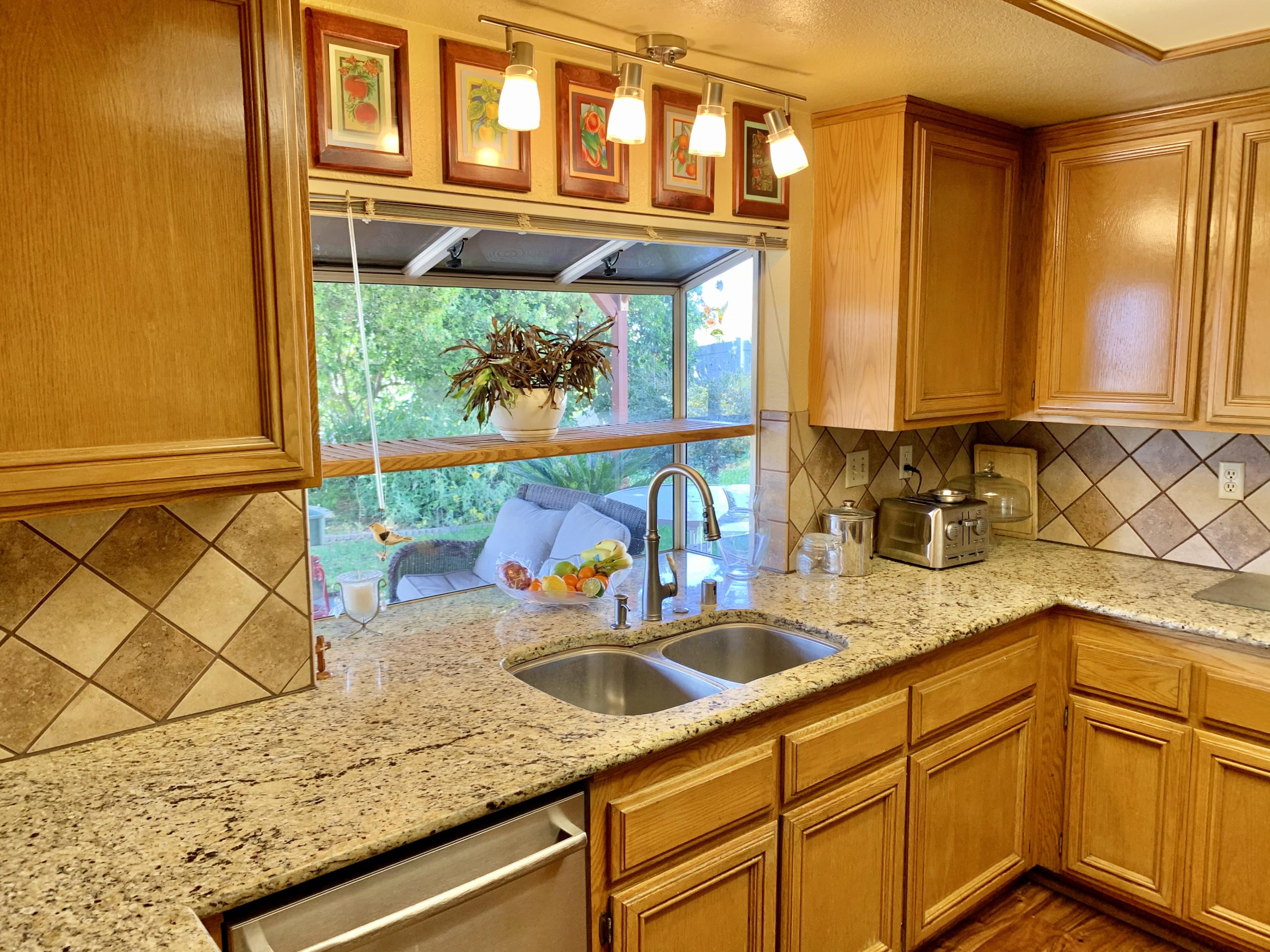 6589 Hawkley Drive Riverside, CA 92506 - Photo 9 of 29 a kitchen with stainless steel appliances granite countertop a sink and a cabinets