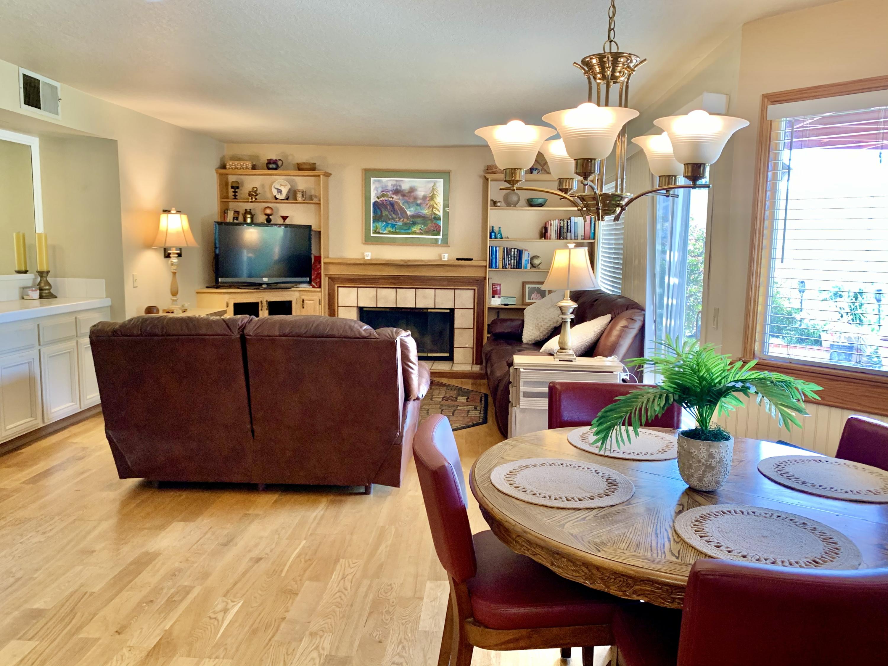 6589 Hawkley Drive Riverside, CA 92506 - Photo 10 of 29 a living room with fireplace furniture dining table and a flat screen tv