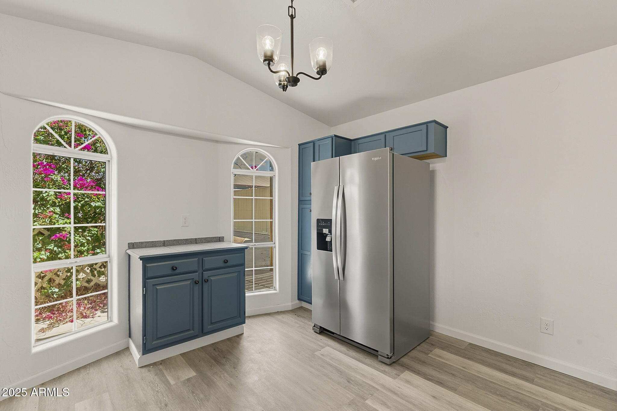 481 West Foothill Street Apache Junction, AZ 85120 - Photo 13 of 50 a view of a kitchen with fridge and wooden floor