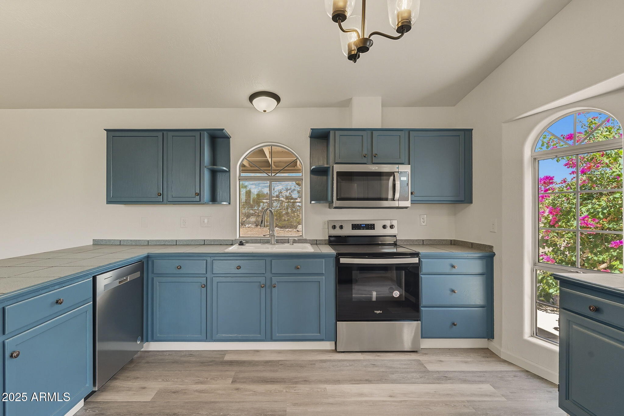 481 West Foothill Street Apache Junction, AZ 85120 - Photo 16 of 50 a kitchen with stainless steel appliances granite countertop a sink and stove top oven