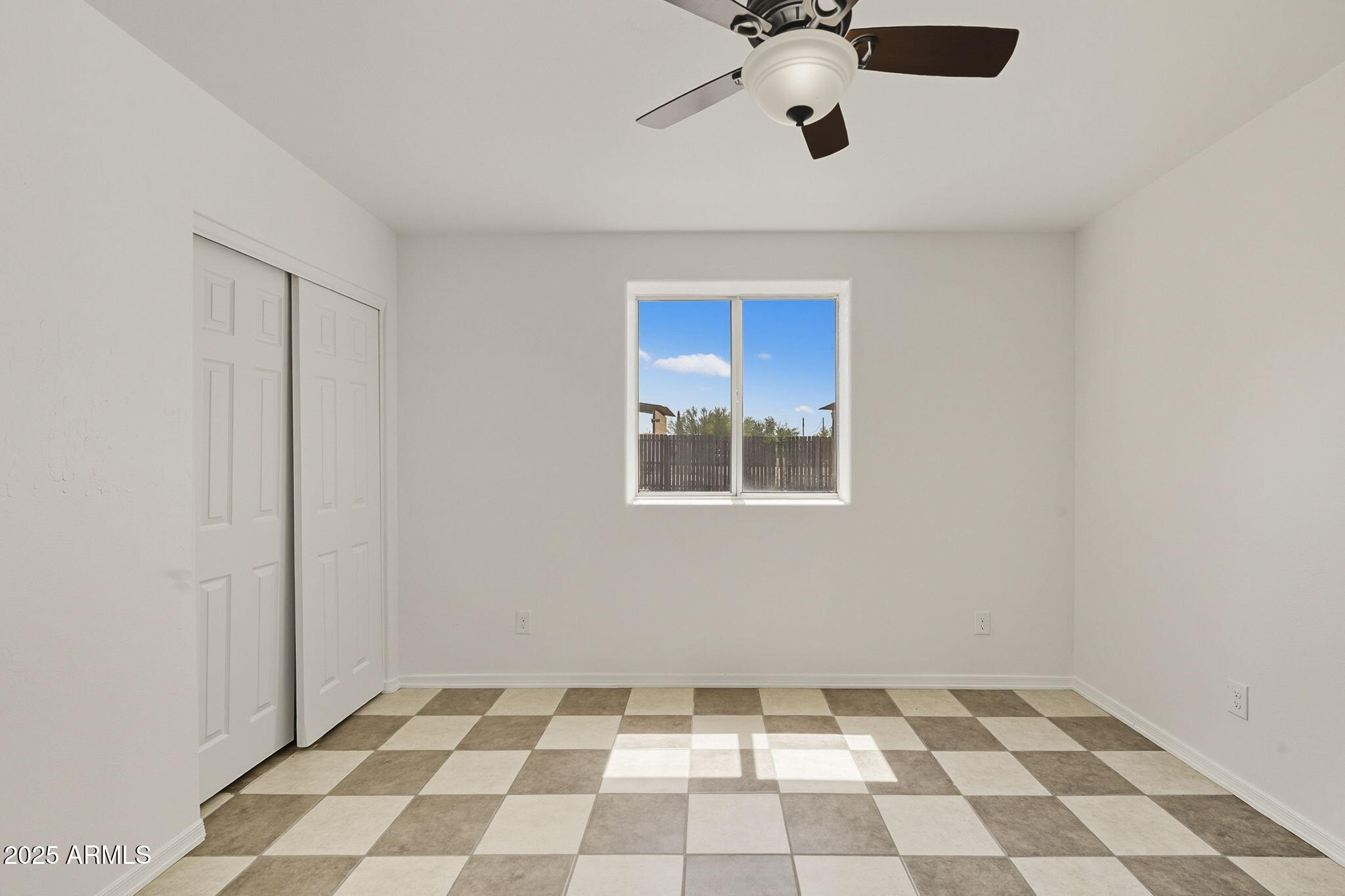 481 West Foothill Street Apache Junction, AZ 85120 - Photo 23 of 50 a view of an empty room with a ceiling fan and a window