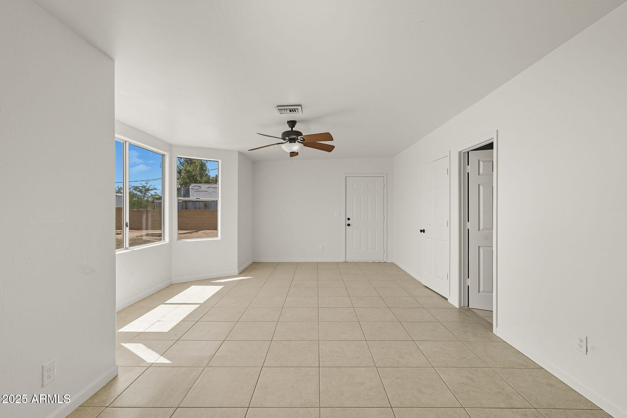 481 West Foothill Street Apache Junction, AZ 85120 - Photo 26 of 50 an empty room with windows and chandelier fan