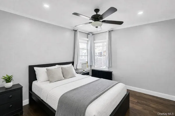 a bedroom with a bed and a potted plant