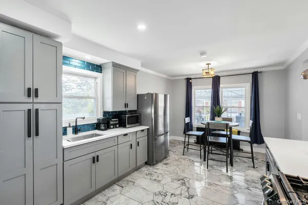a kitchen with sink cabinets and refrigerator