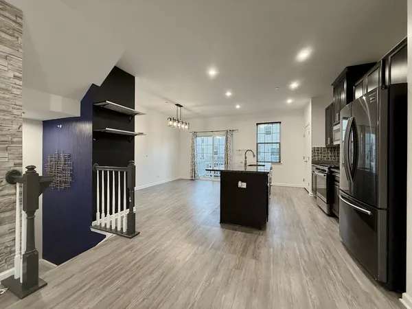 a kitchen with a refrigerator and a stove top oven