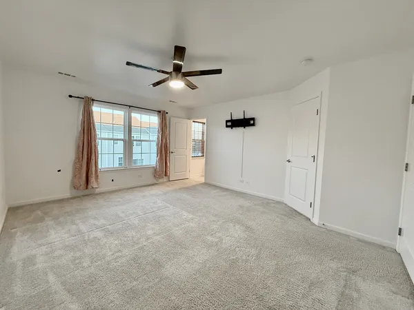 a view of empty room with ceiling fan