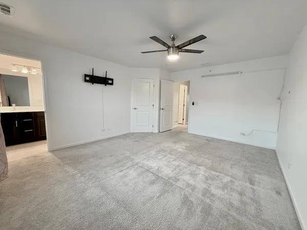 a view of a livingroom with a ceiling fan and window