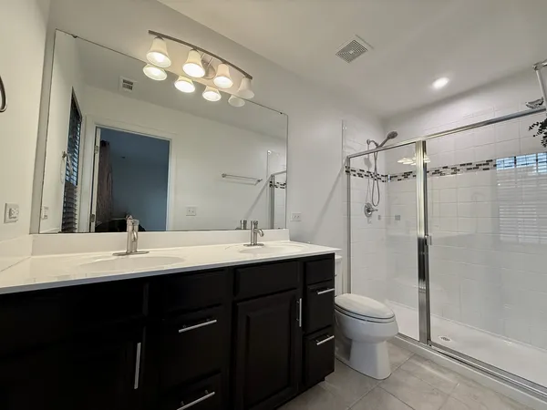 a bathroom with a sink toilet and shower