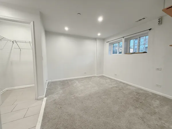 an empty room with windows and closet