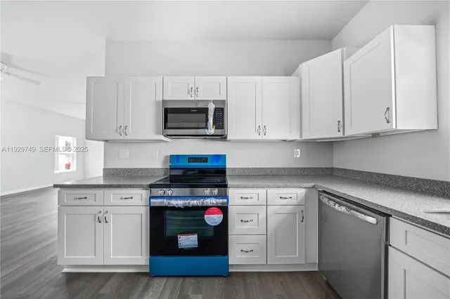 a kitchen with stainless steel appliances granite countertop a refrigerator and a sink