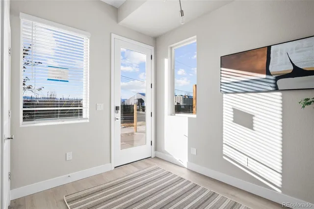 a view of a livingroom with wooden floor and a window