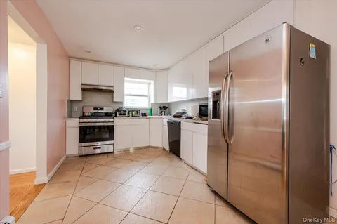a kitchen with granite countertop a refrigerator and a sink