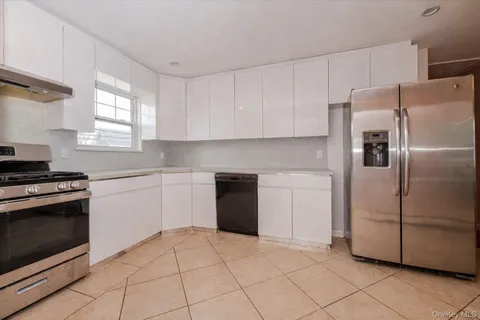 a kitchen with a refrigerator sink and cabinets