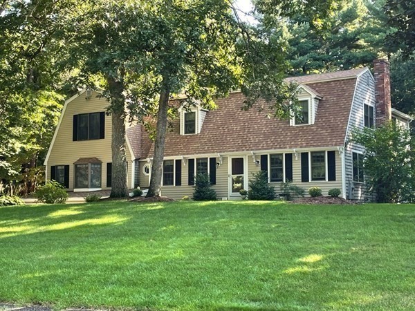 a front view of house with yard and green space