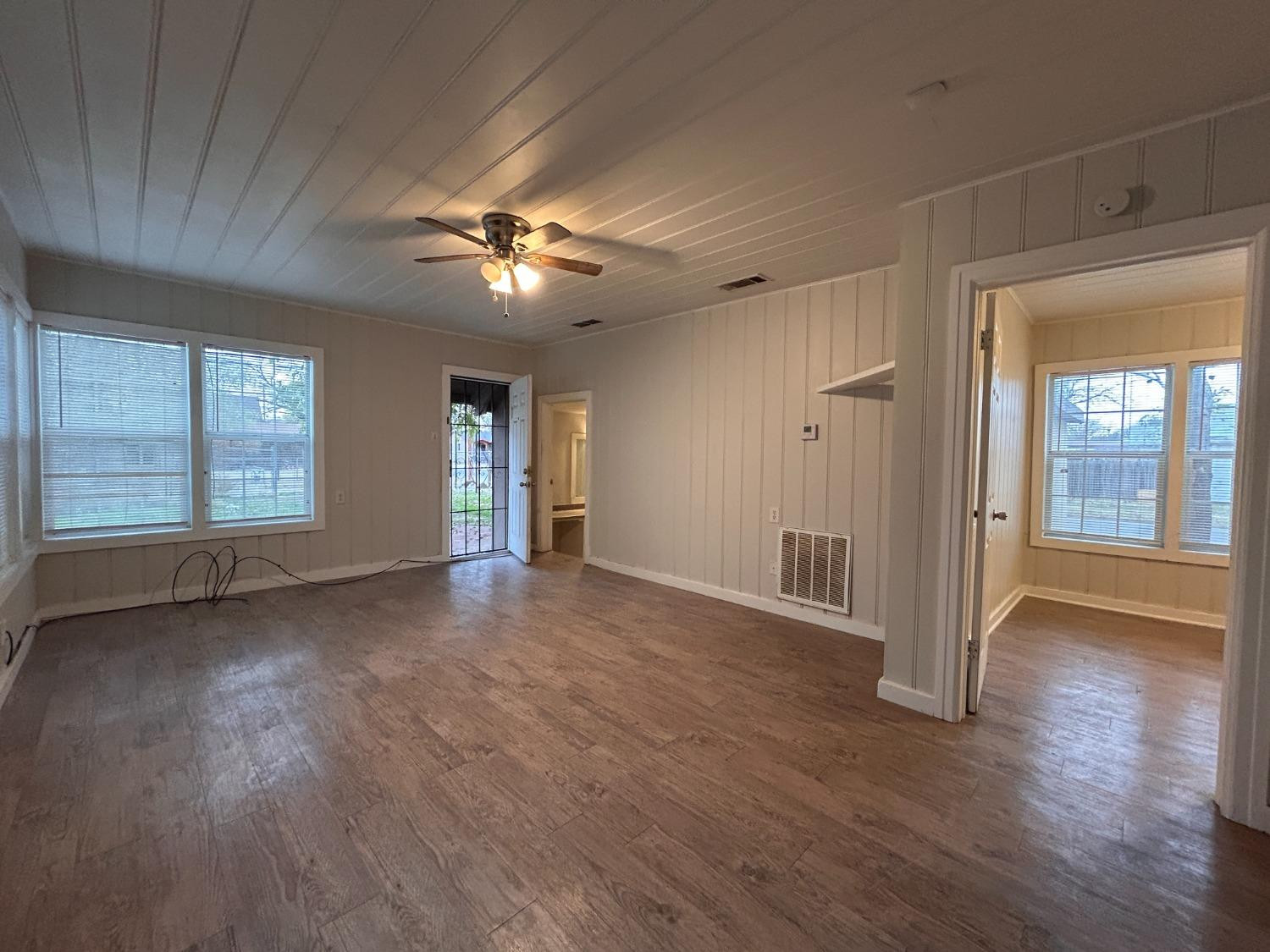 1925 26th Street Lubbock, TX 79411 - Photo 5 of 10 a view of empty room with wooden floor and fan