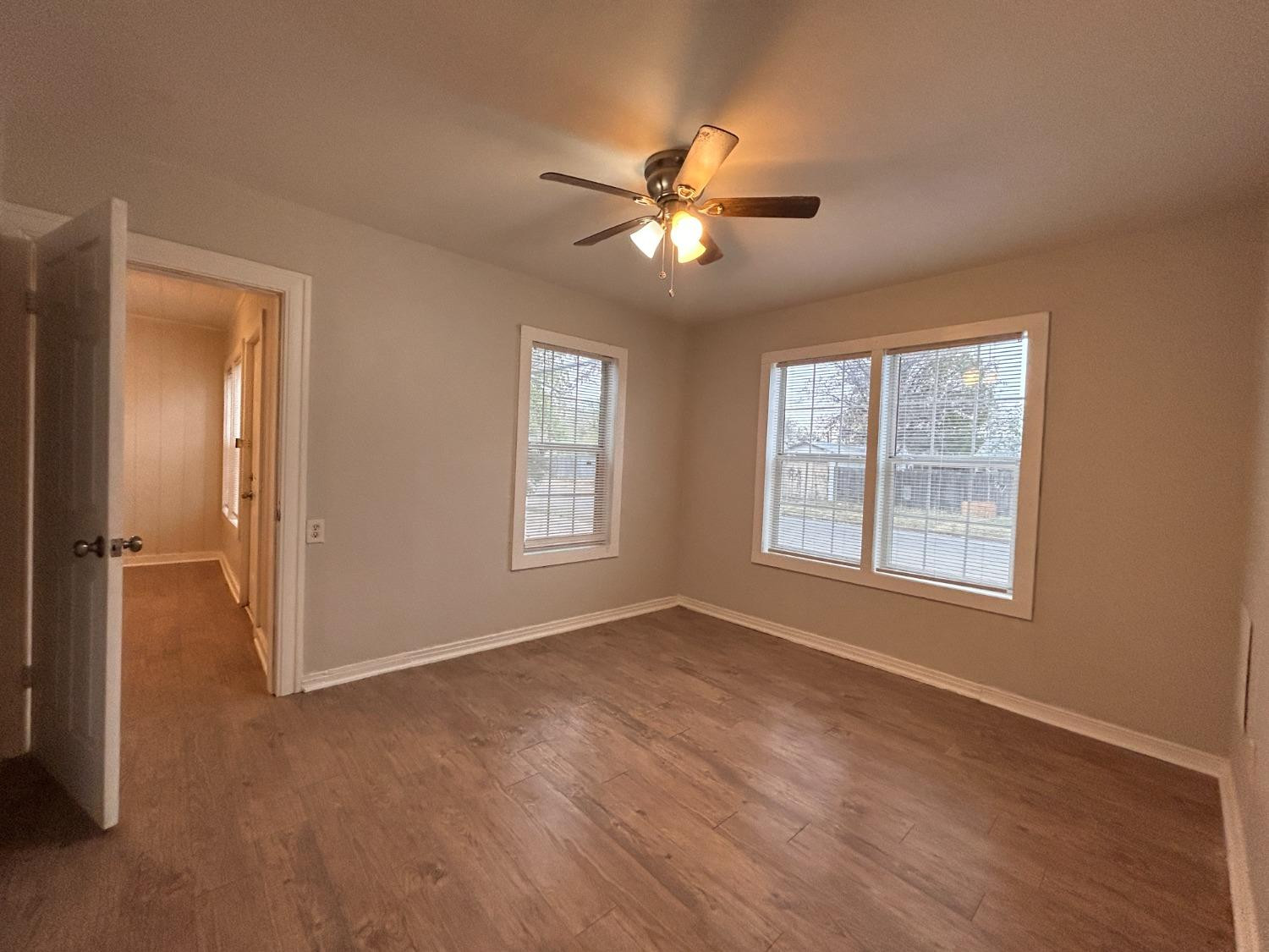1925 26th Street Lubbock, TX 79411 - Photo 10 of 10 a view of an empty room with a window and wooden floor