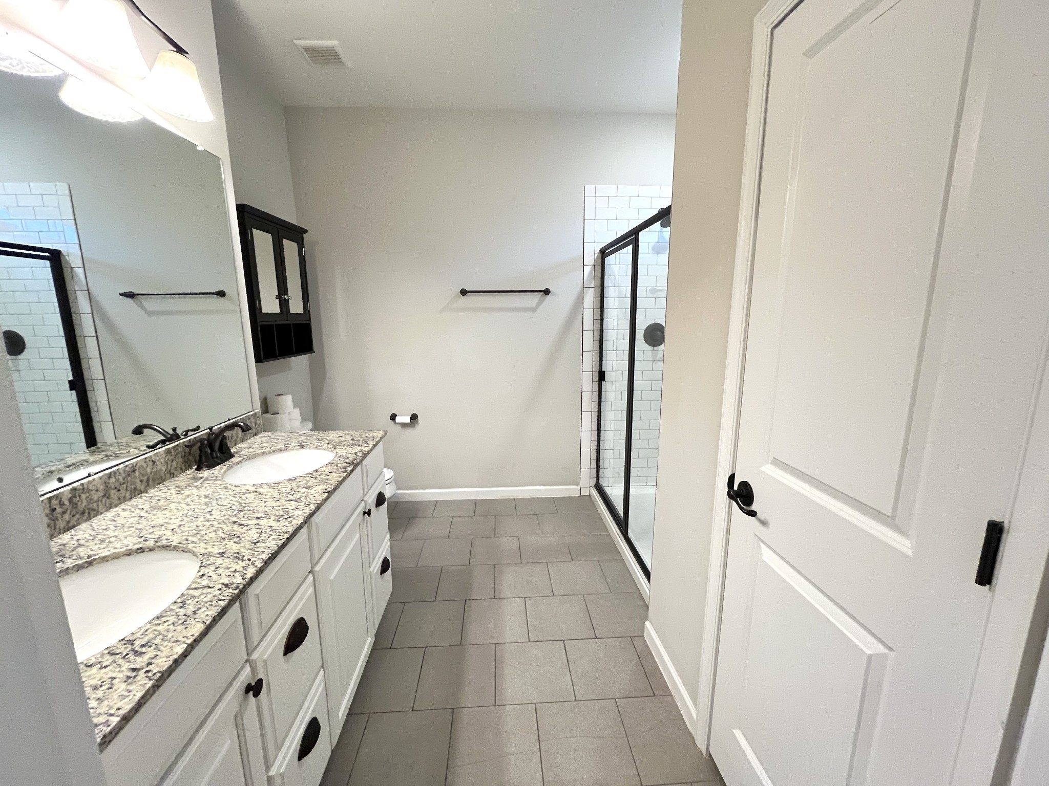 2817 Bluestem Lane Murfreesboro, TN 37128 - Photo 21 of 33 a bathroom with a granite countertop sink a mirror and shower