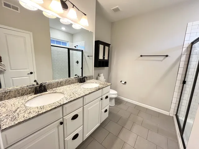 a bathroom with a granite countertop sink a mirror and a