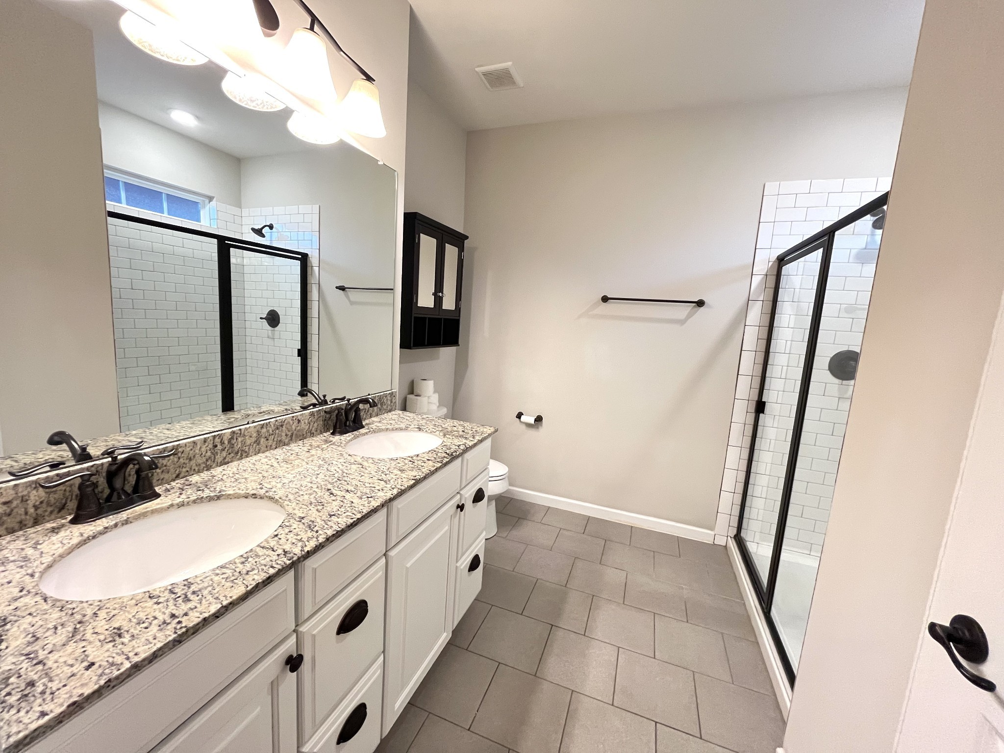 2817 Bluestem Lane Murfreesboro, TN 37128 - Photo 25 of 33 a bathroom with a granite countertop sink a mirror and shower