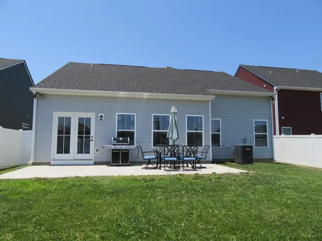 a front view of house with yard and green space