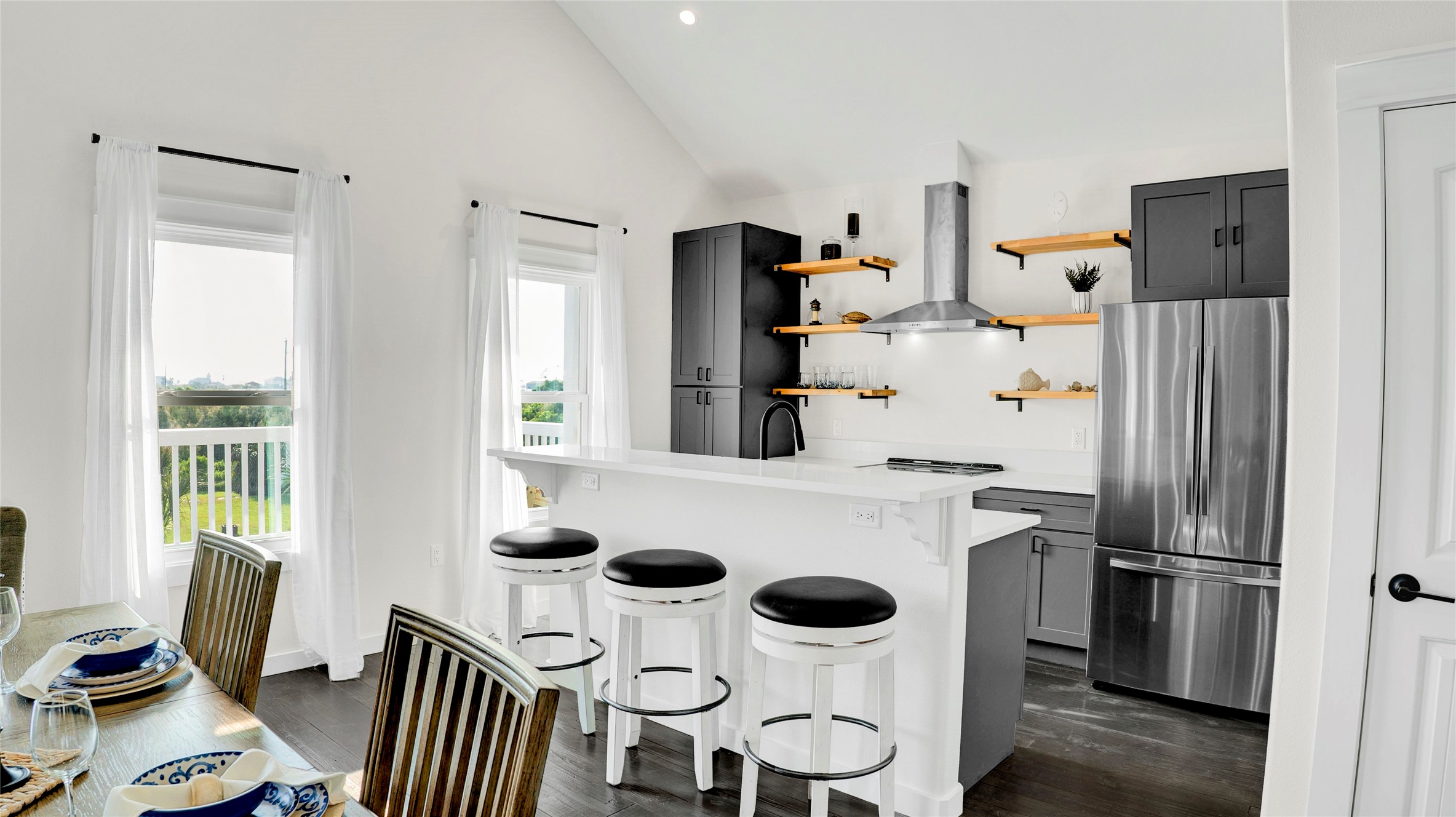 1065 Sunset Circle Crystal Beach, TX 77650 - Photo 16 of 50 a kitchen with a refrigerator and wooden floor