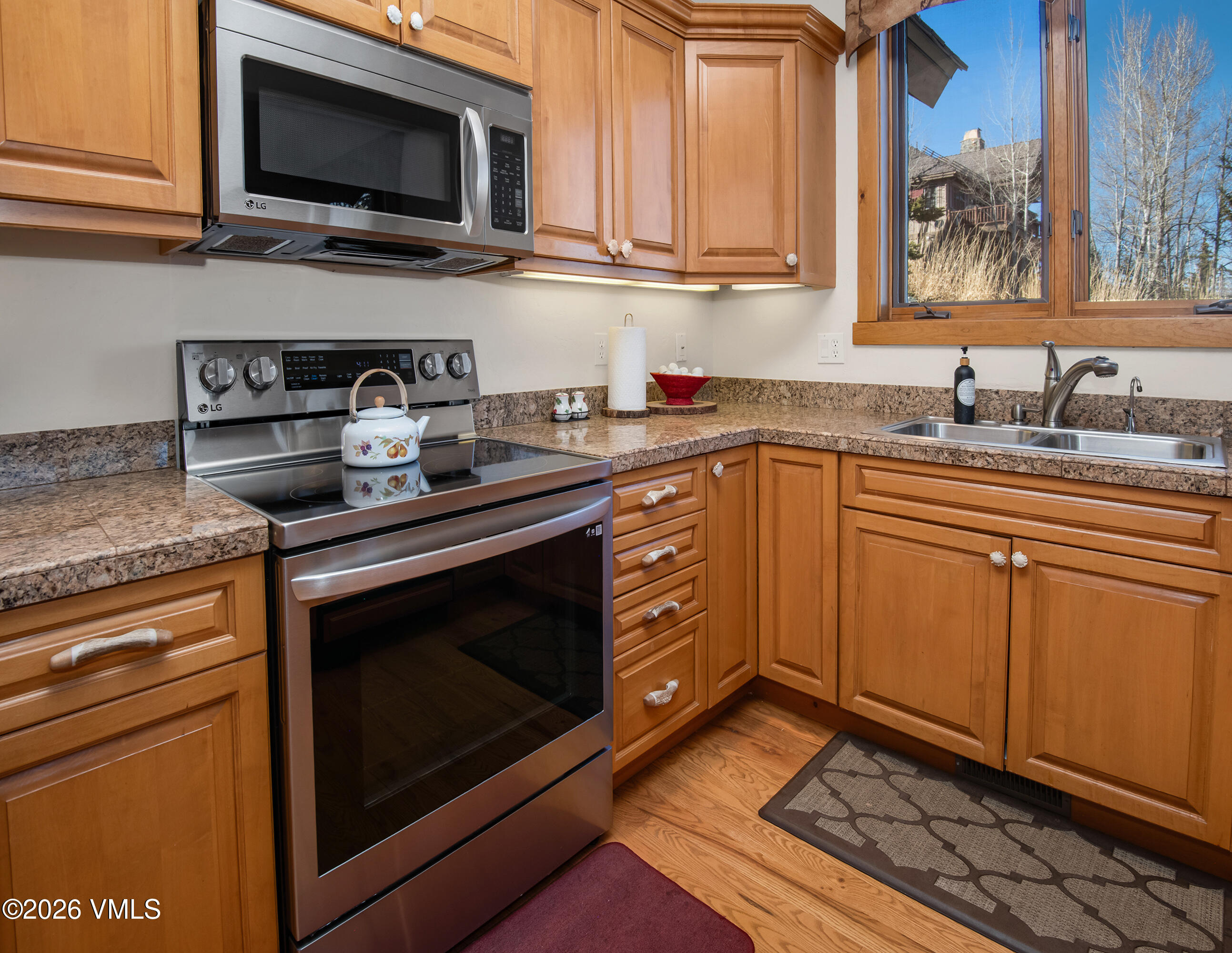181 Club Cottage Drive Edwards, CO 81632 - Photo 12 of 34 a kitchen with stainless steel appliances granite countertop a sink stove and microwave