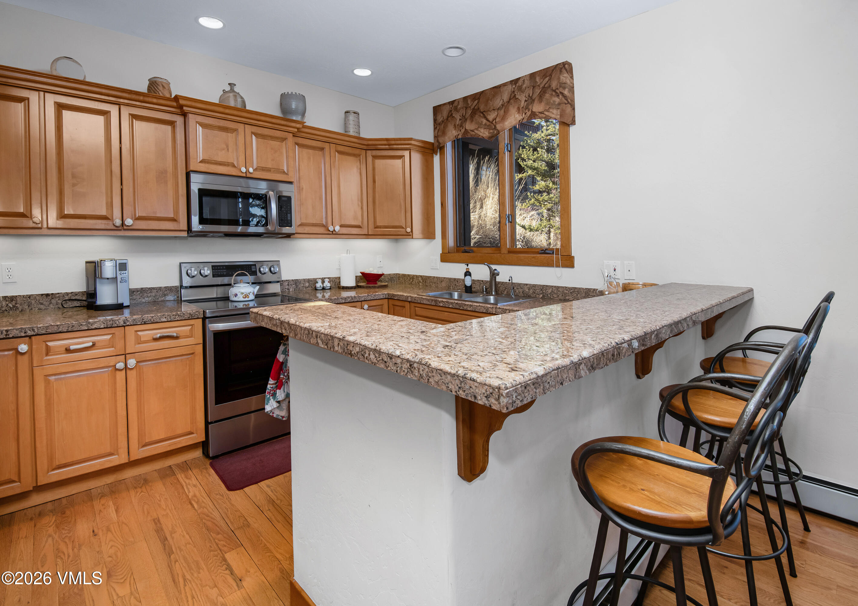 181 Club Cottage Drive Edwards, CO 81632 - Photo 13 of 34 a kitchen with granite countertop a stove a sink and a microwave
