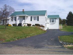 3945 Rockfish Road Grottoes, VA 24441 - Photo 1 of 7 a front view of a house with a yard and garage