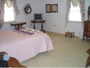 3945 Rockfish Road Grottoes, VA 24441 - Photo 7 of 7 a bedroom with a bed and a table in it