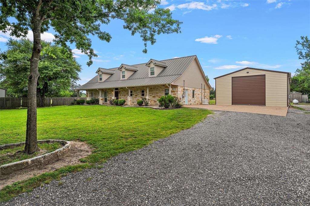 1117 Downsville Road Robinson, TX 76706 - Photo 4 of 40 Stone and siding exterior with a metal roof and three dormer windows