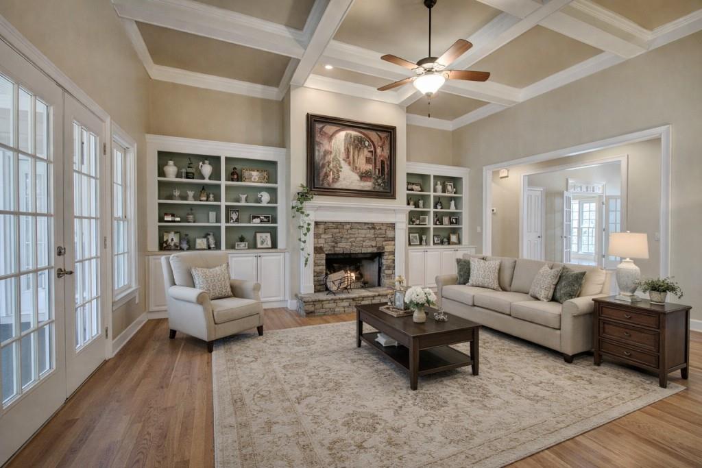 302 Waterfall Court Canton, GA 30115 - Photo 14 of 80 a living room with furniture a fireplace and a large window