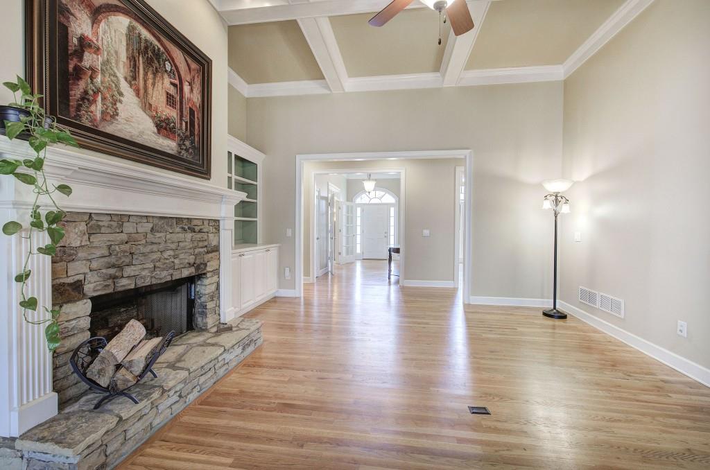 302 Waterfall Court Canton, GA 30115 - Photo 16 of 80 a view of a livingroom with wooden floor and a fireplace