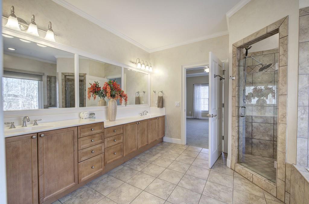 302 Waterfall Court Canton, GA 30115 - Photo 22 of 80 a bathroom with a double vanity sink mirror and shower