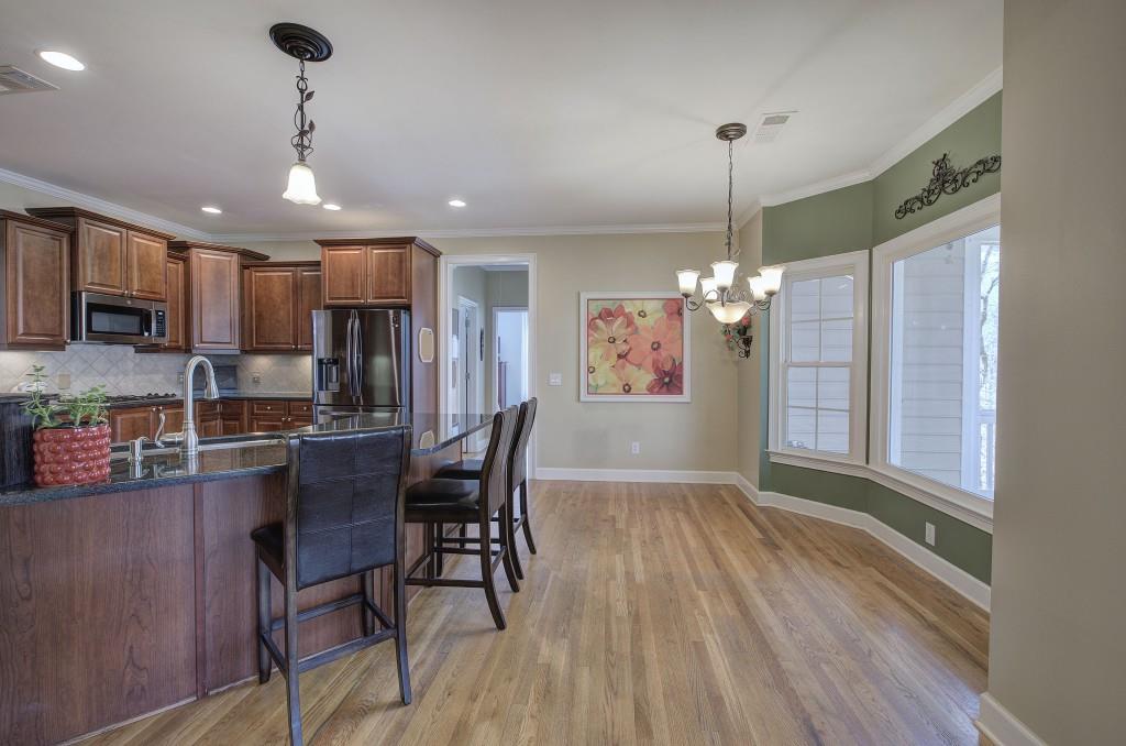 302 Waterfall Court Canton, GA 30115 - Photo 27 of 80 a view of a dining room with furniture window and wooden floor