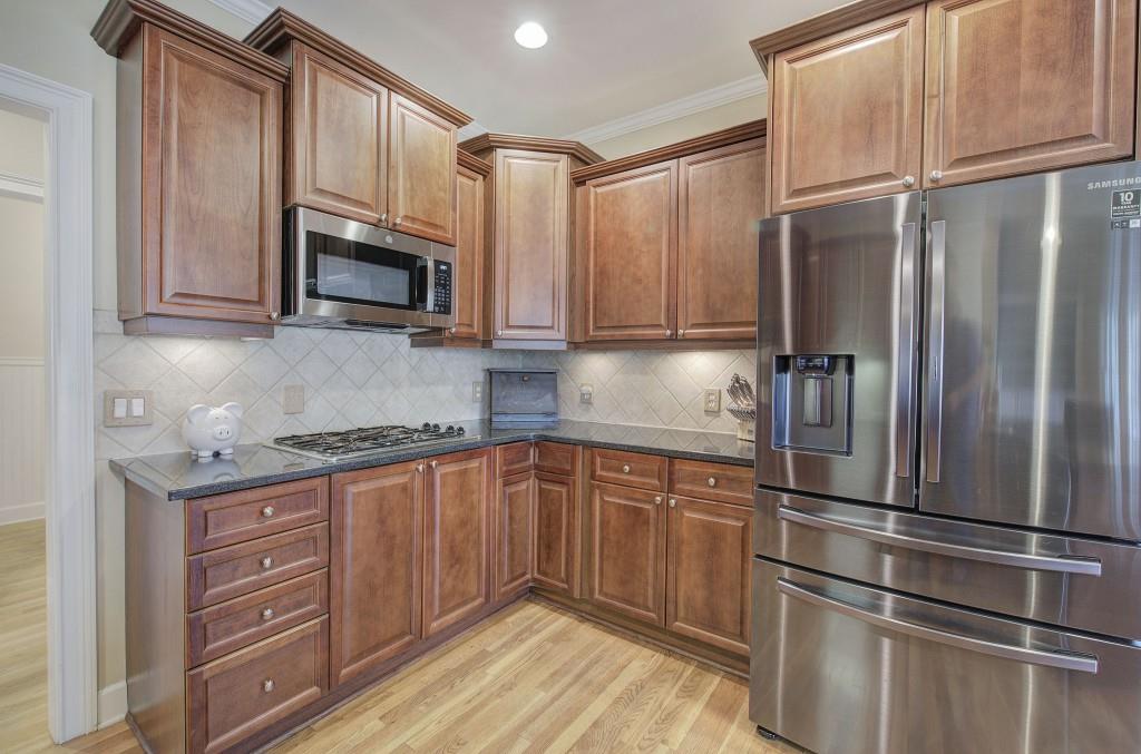 302 Waterfall Court Canton, GA 30115 - Photo 30 of 80 a kitchen with granite countertop stainless steel appliances a refrigerator stove microwave and sink