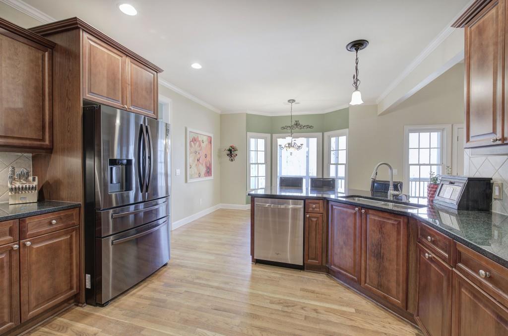 302 Waterfall Court Canton, GA 30115 - Photo 32 of 80 a kitchen with granite countertop stainless steel appliances a sink cabinets and a counter top space