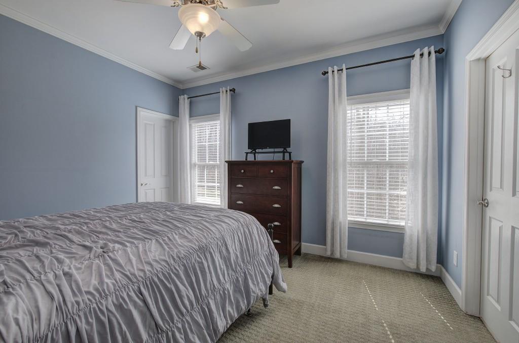 302 Waterfall Court Canton, GA 30115 - Photo 34 of 80 a bedroom with a bed and a flat tv screen on dresser