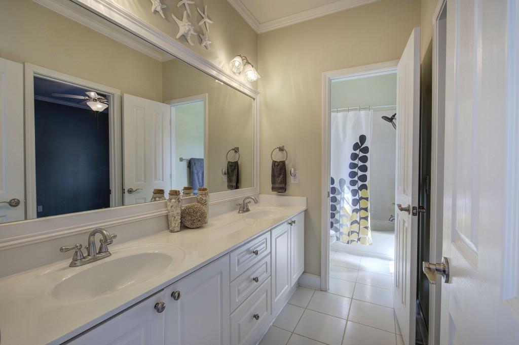 302 Waterfall Court Canton, GA 30115 - Photo 35 of 80 a bathroom with a double vanity sink and a mirror