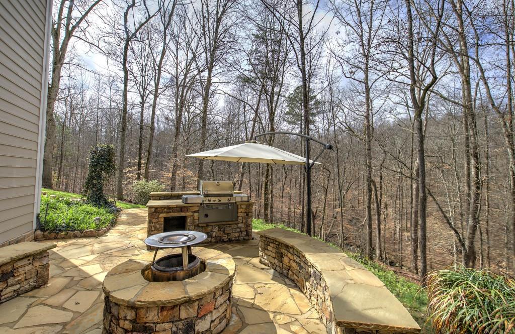 302 Waterfall Court Canton, GA 30115 - Photo 54 of 80 a backyard of a house with table and chairs under an umbrella