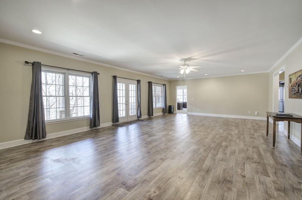 302 Waterfall Court Canton, GA 30115 - Photo 59 of 80 a view of an empty room with wooden floor and a window