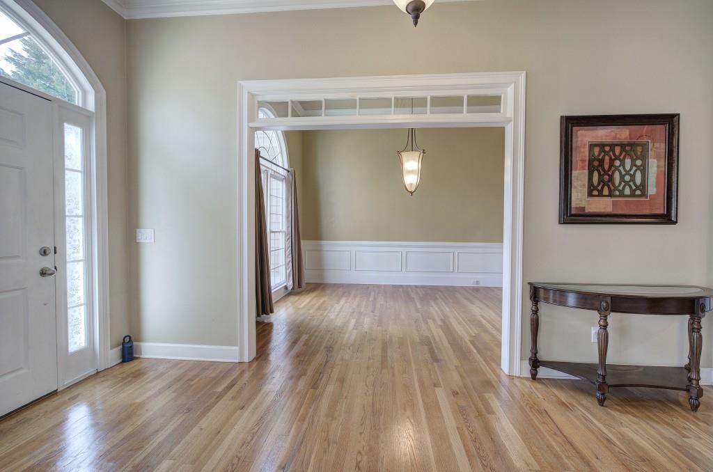 302 Waterfall Court Canton, GA 30115 - Photo 9 of 80 an empty room with wooden floor and a mirror
