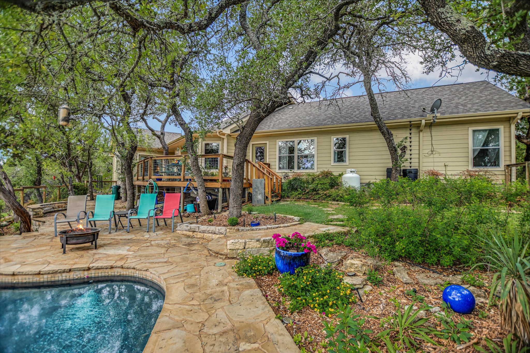 590 Rancho Grande Drive Wimberley, TX 78676 - Photo 27 of 30 a view of a house with a backyard and a tree