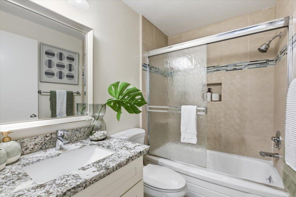 280 Easy Street, Unit 307 Mountain View, CA 94043 - Photo 26 of 30 a bathroom with a granite countertop sink a toilet and shower