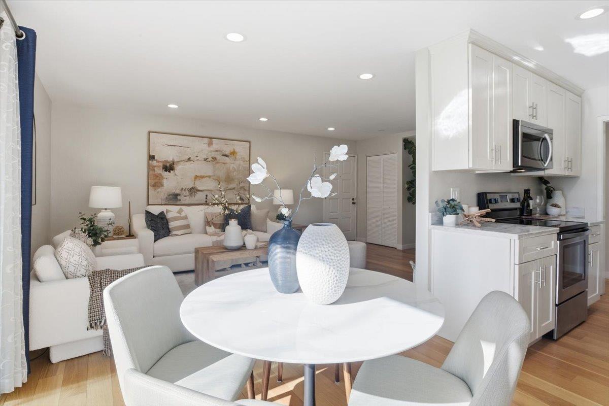 280 Easy Street, Unit 307 Mountain View, CA 94043 - Photo 10 of 30 a living room with furniture a flat screen tv and kitchen view