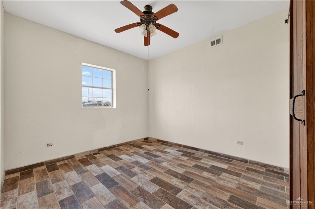 1424 North Sky Soldier Road Weslaco, TX 78596 - Photo 18 of 33 a view of a room with a ceiling fan and a window