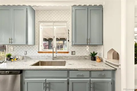a kitchen with granite countertop a sink and a window
